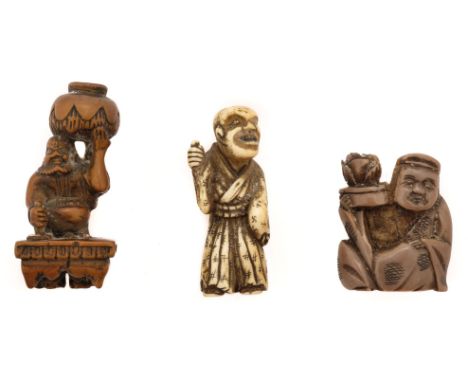 * Netsuke. A Japanese ivory netsuke, Meiji period 1868-1912, carved as an elder wearing a cloak with swastika symbols, 5cm hi