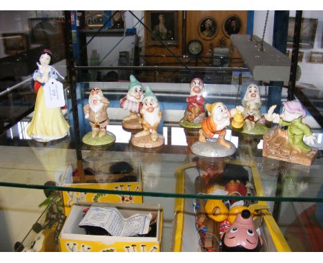 A Royal Doulton Walt Disney 'Snow White' SW9 figure, together with assorted Dwarfs - 'Sneezy' SW14, 'Bashful' SW16, 'Doc with