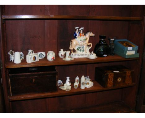 Two shelves of collectables, including tea caddy, Staffordshire flatback, crested china
