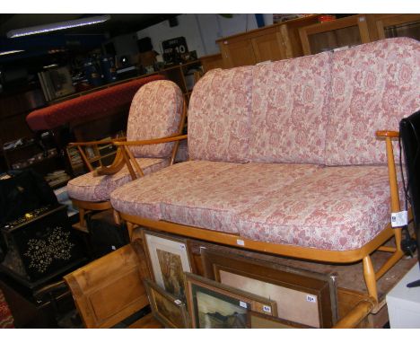 A vintage mid century three seater Ercol sofa, together with armchair and rocking chair 