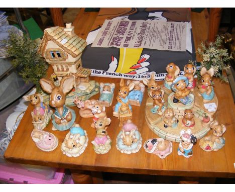 A collection of Pendelfin Rabbit ornaments and associated stands 