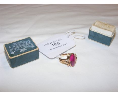 An oval pink stone dress ring