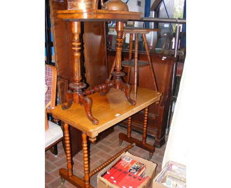 An antique library table on bobbin supports, together with two occasional tables of varying shape and style 