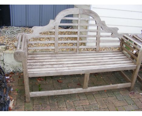 A slatted wooden garden bench with rolled armrests - width 165cm 