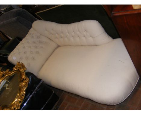 An antique chaise lounge upholstered in new light cream material