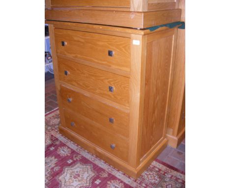 A contemporary light oak four drawer chest with square metal handles - width 85cm 