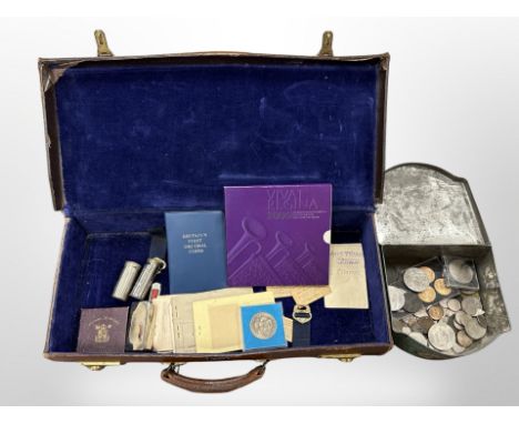 A vintage leather suitcase containing mixed British and foreign coins, crowns, ration books, two sixpence coin boxes, 