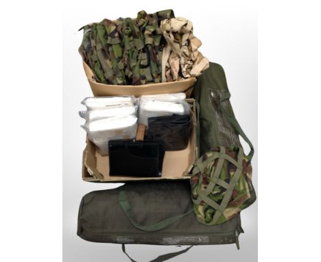 Two boxes of army camouflage hats, military camping beds in carry bags, leather pouches 