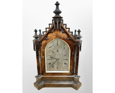 An impressive Victorian Gothic Revival carved oak bracket clock, the 23cm arched silvered Roman dial signed Robert H. Halford