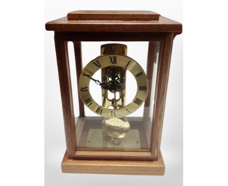 A contemporary German mantel clock with skeletonised movement, height 22 cm 