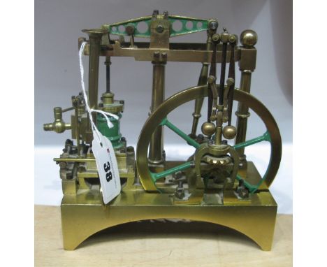 A XIX Century Brass Model of a Three Pillar Beam Engine with Regulator, 6 inches long, 6 1/2 inches high, 3 inches wide. Well