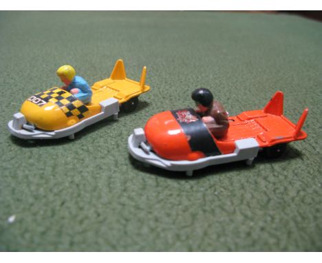 Two James Bond OHMSS Original Corgi Junior Bobsleighs, one Spectre, one 007, both fair/good with plastic surrounds.