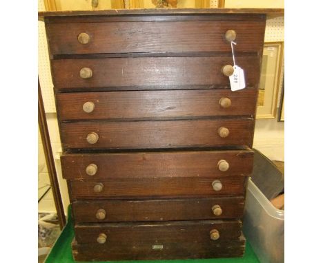 An A. W. Gamage collector's cabinet with eight glazed drawers containing a collection of fishing flies and vintage fishing ta