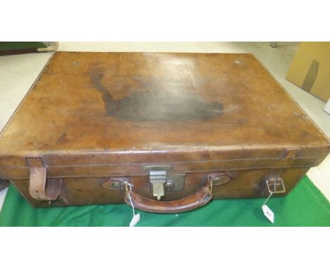 A vintage leather suitcase stamped "50 Army & Navy CSL Makers London"