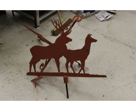 A large weather vane with decorated with deer