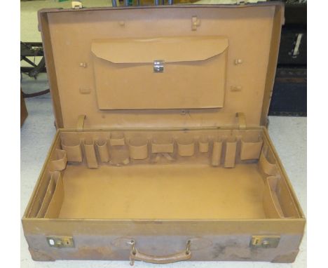 A leather-bound suitcase with fitted interior, stamped "Asprey London" and set with insignia to top in the form of a capital 