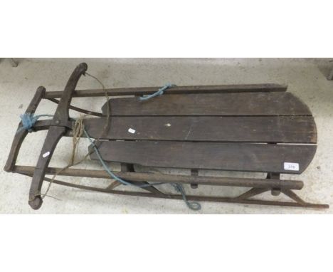 A wood and iron framed vintage tobbogan