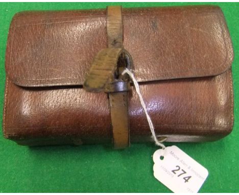 A leather fly fisherman's wallet containing parchment leaves and two alloy inserts containing a quantity of salmon and sea tr
