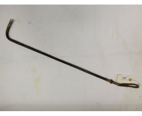 A ladies side saddle whip with cane shaft and silver ferrule