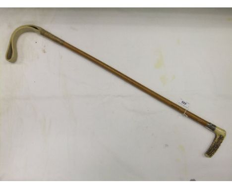 A gents hunting crop with malacca shaft and white metal ferrule embossed with running fox and initialled with cartouche and b