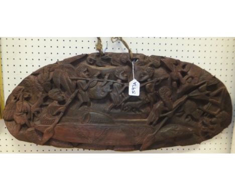 An Eastern carved wood plaque depicting a hunting scene (possibly Papua New Guinea)