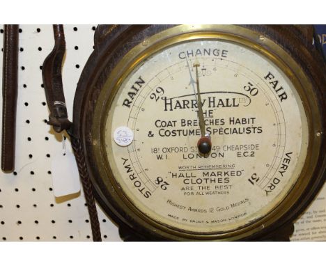 An oak cased barometer thermometer, the barometer dial inscribed Harry Hall Limited "The Coat Coach Breeches Habit & Costume 