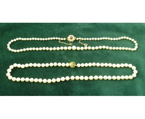 A GRADUATED SINGLE STRAND OF CULTURED PEARLS with 9ct gold, garnet and pearl set clasp, 49cm, (with original bill of sale fro