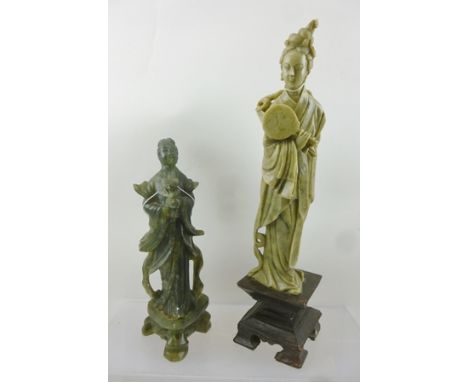 TWO CHINESE CARVED STONE SCULPTURES, both Bijin, in flowing robes, one with flowers, the other a mirror or fan, raised on pla