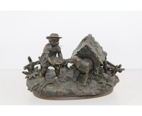 A LATE 19TH CENTURY BRONZE NOVELTY INKWELL, cast as a boy feeding a dog emerging from his kennel, the kennel roof hinged open