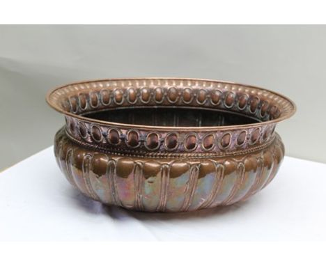 A LATE 19TH CENTURY EMBOSSED COPPER PLANTER OR WINE COOLER, of oval form with turn-over rim, 52cm x 41cm 