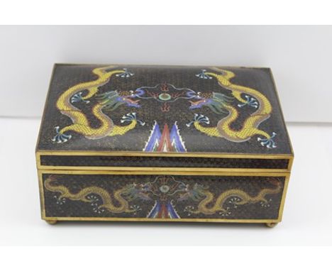 A 20TH CENTURY CLOISONNE TABLE CASKET, the black ground, decorated with five-toe dragons pursuing the pearl of wisdom, having