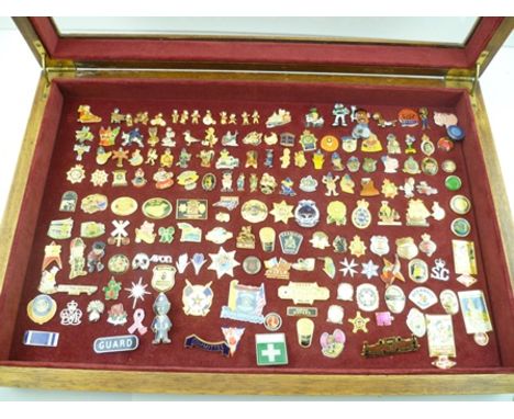 A COLLECTION OF OVER 160 ENAMEL AND BRASS LAPEL BADGES, mostly of Police and Law Enforcement interest, contained in an oak di