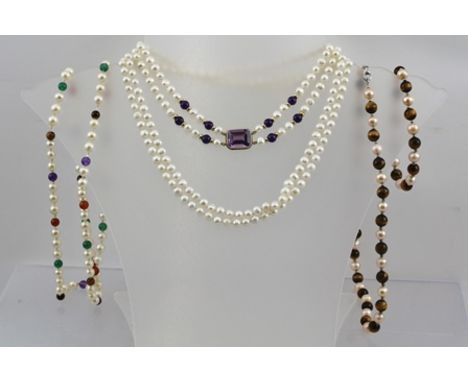 A DOUBLE STRAND OF CULTURED PEARLS, mounted with a 9ct gold set facet cushion cut stone, possibly an amethyst, together with 