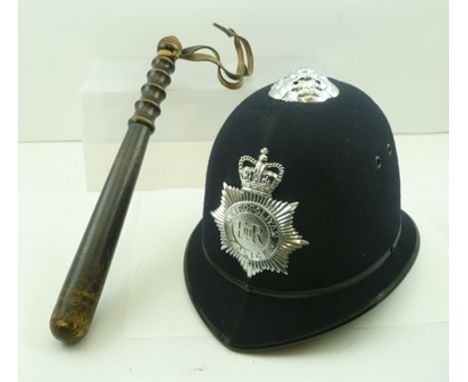A METROPOLOTAN POLICE HELMET with badge, together with a turned wood truncheon and a "Warwickshire Police" uniform 