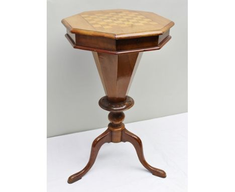 A VICTORIAN WALNUT WORK TABLE, the octagonal top inset with chequerboard, needlework storage to centre, raised on tripod supp