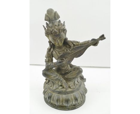 A 19TH CENTURY SINO-TIBETAN BRONZE, depicting a seated Celestial Musician, with stringed instrument, seated upon a lotus plat