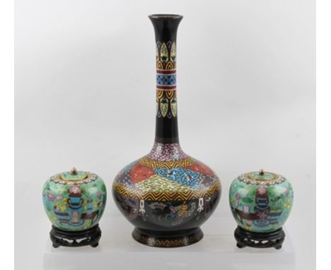 A PAIR OF 20TH CENTURY CLOISONNE JARS WITH COVERS, having jade green ground, decorated with items of contemplation, vases etc