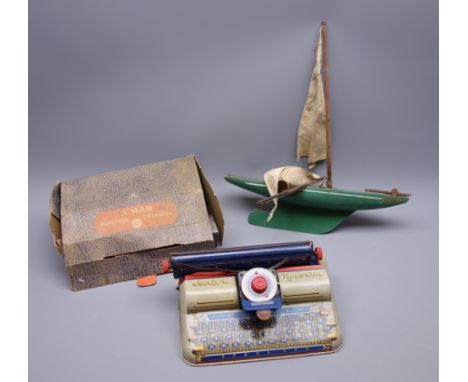Marx Lumar Junior child's tin-plate typewriter L28cm, boxed, and Astra-1 pond yacht with green painted wooden hull and metal 
