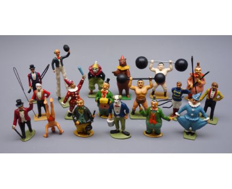 Eighteen predominantly modern die-cast circus figures including clowns, ring masters, stilt walker, strongmen, acrobat, perfo