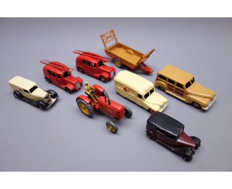 Dinky - eight unboxed and playworn early die-cast models including two fire engines each with ladder and bell, Massey Harris 