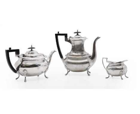 A three piece silver tea service, by Walker &amp; Hall, Sheffield 1906, by comprising a coffee pot, 24cm high, teapot, 16cm h