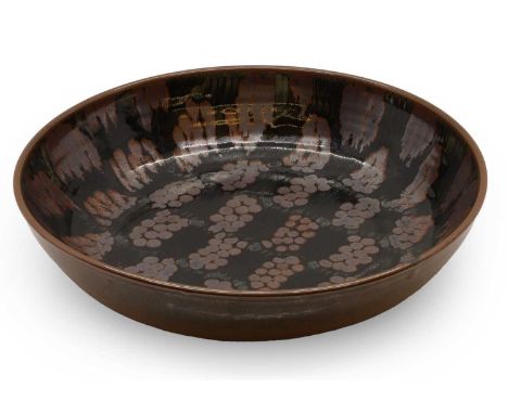 A large studio pottery charger,  20th century, by David Lloyd Jones, circular form with blue glaze and repeated stylised deco