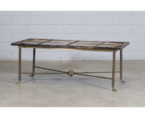 An Art Deco bronze coffee table, c.1925, French, with arched banding over a mirrored and smoked glass top, labelled 'Paris 19