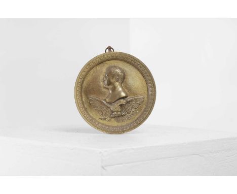 A bronze round medallion of Napoleon Bonaparte,  c.1820, French, with a profile portrait cast in relief over an eagle,  11.8c