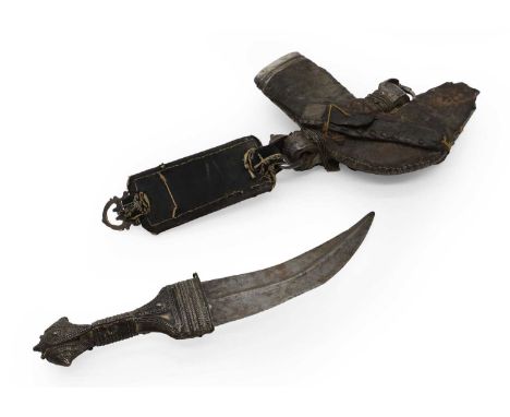 A jambiya and scabbard, 19th to 20th century, possibly Yemeni, with brass mounts,30cm long