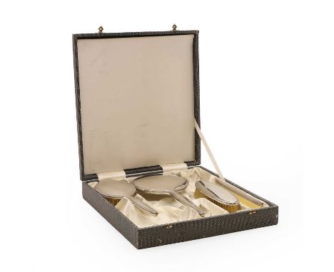A silver mounted dressing table set, comprising a hairbrush, 23.5cm, a hand mirror, 28cm long, together with a clothes brush,