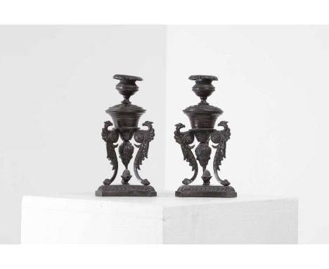 A pair of grand tour bronze candlesticks, late 19th/early 20th century, each decorated in the Renaissance style with stylised