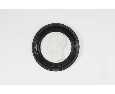A Bing & Grøndahl bisque porcelain plaque, 19th century, of circular form, depicting a profile portrait of Christian IX of De