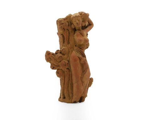 A terracotta figure,  probably Indonesian, of a dancer, against a tree trunk, 32cm highProvenance: The Collection of David an