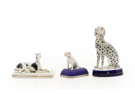 A Chamberlain Worcester porcelain figure,  c.1830, of a white dog sitting on a blue cushion, painted marks, 7cm high together